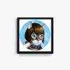 The Anna Kitty framed art print features a white and brown cat with round glasses, green eyes, and a blue shirt, set against a light blue background.