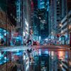 The art print Twin World captures a nighttime city street scene with brightly illuminated tall buildings, blue and red neon lights reflecting off the wet pavement. A few pedestrians stroll while blurred cars in the background enhance its urban atmosphere.