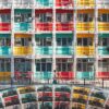 The Rainbow Apartment displays rows of windows in red, teal, and yellow. Below, a woman walks by a curved mirrored surface reflecting the structure. The vibrant scene resembles an art print, beautifully capturing dynamic urban life and architecture.