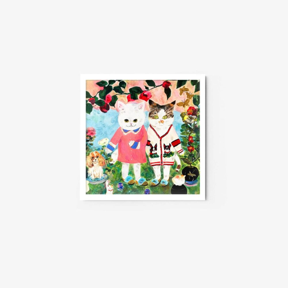 The Happy Garden art print showcases two cats in pink and gray outfits amidst a flower-filled garden, with a playful small dog and another cat nearby, creating a vibrant scene.