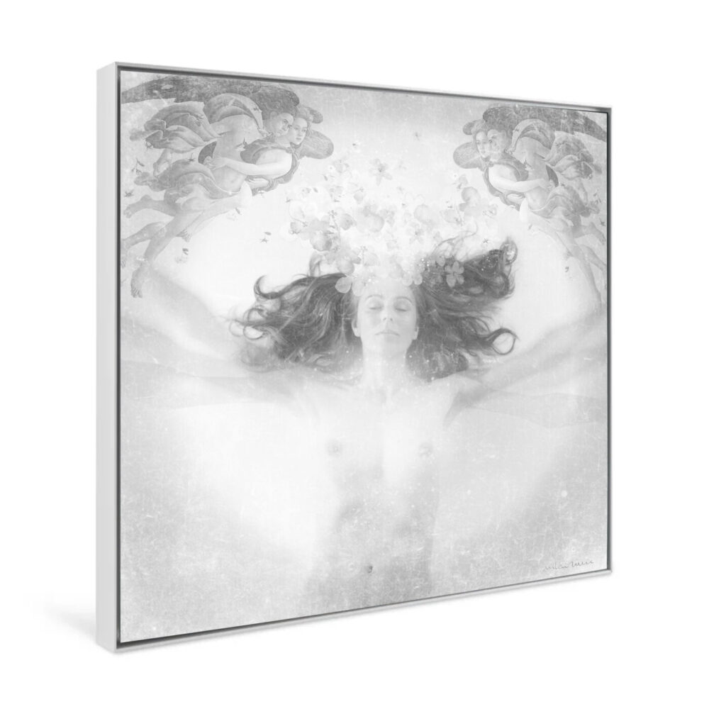 The grayscale art print Ingrávido 001 depicts a person lying peacefully underwater amidst flowers and butterflies, surrounded by angelic figures in the corners, creating an ethereal, dreamlike scene with otherworldly charm.
