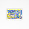 A Trip art print features swirling shapes and patterns in vibrant yellow, blue, and purple hues. Its design includes stars, musical notes, and whimsical forms on a white background with a border, creating dynamic motion.