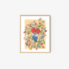 The Candy Heart art print shows a character with red hair and a suit surrounded by colorful fruits and vegetables, set against a warm yellow background. It is elegantly framed in a simple wooden frame.