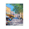 The art print The Sunlit Yellow Cafe Terrace, 2024 depicts a vibrant European street with strolling people, café tables, and buildings under a clear blue sky. A large tree adds shade to the bustling scene, capturing the lively charm of the setting.