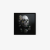 A framed art print titled Skeleton Flower (Diphylleia grayi) features a tilted human skull amid dark green leaves and white flowers with yellow centers against a black backdrop, adding depth and dimension.