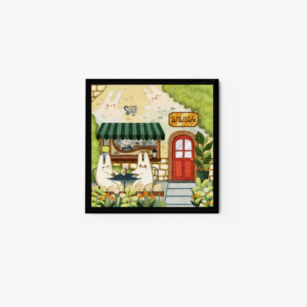 The art print Cafe Outside captures two rabbit-like creatures seated at a table outside a quaint cafe with a green striped awning, red door, and Luvi cafe sign, all surrounded by lush greenery and flowers.