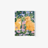 The art print Full of Love showcases an orange cat and a fluffy brown dog in a garden, surrounded by colorful flowers and lush greenery, all elegantly framed by a crisp white border.