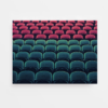 The art print Applause features a stadium seating arrangement with rows of red seats at the top and dark green seats below, creating a striking color contrast. The unoccupied seats form a symmetrical pattern, enhancing the visual appeal.