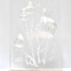 The Ever-blooming no.3 is a clear rectangular resin block that encases delicate plant stems and flowers, resembling an art print. Elegantly displayed on a wooden base, the translucent material unveils intricate natural details, creating a striking visual effect.