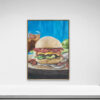 The framed painting Guilty Pleasure, 2016 features a burger with lettuce, bacon, and cheese against a vibrant blue backdrop, subtly paired with a drink. It adds a quirky touch to any white wall above plain surfaces.